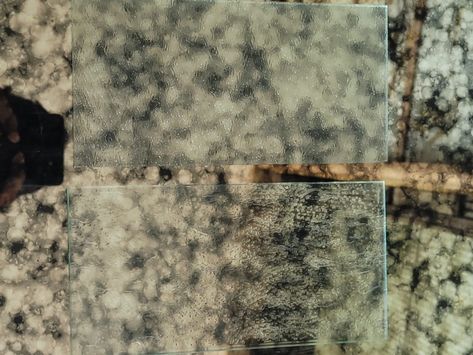 Textured clear glass samples — Two clear glass samples showing contrasting surface textures.