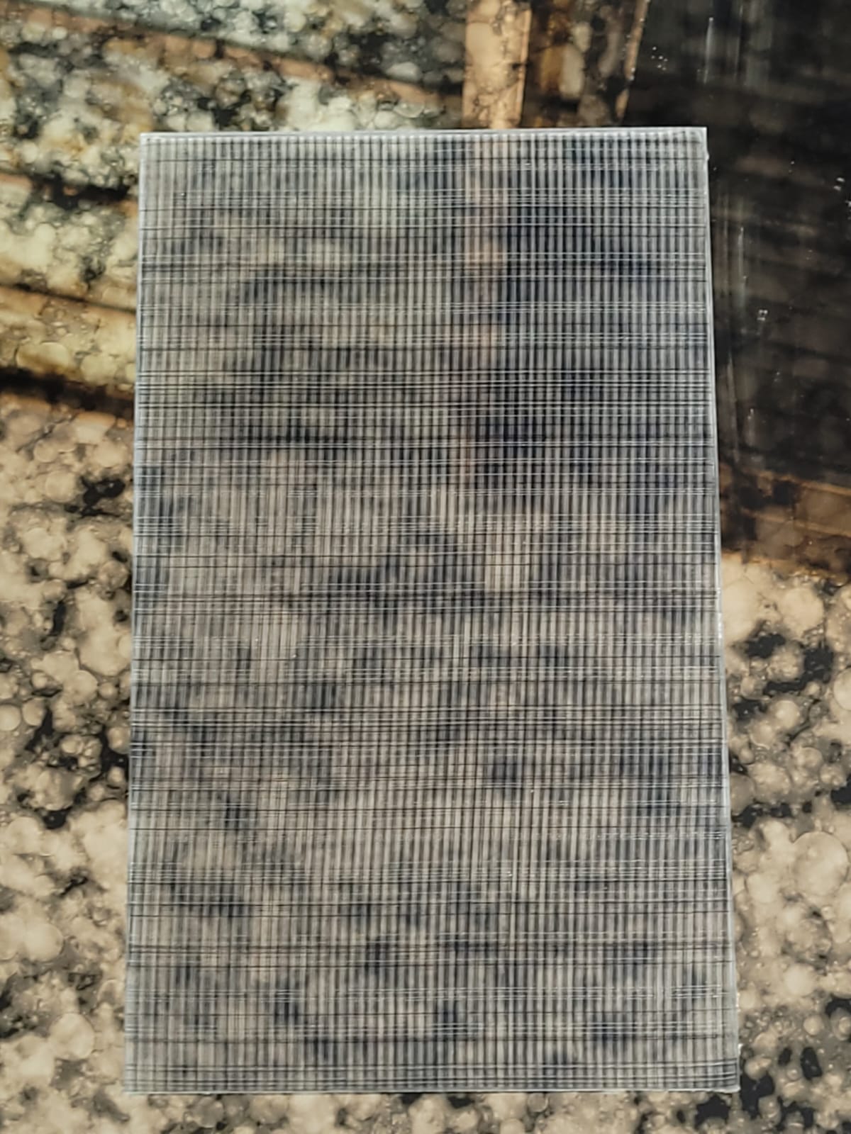 Fine grid glass — A closely spaced grid across a clear pane.