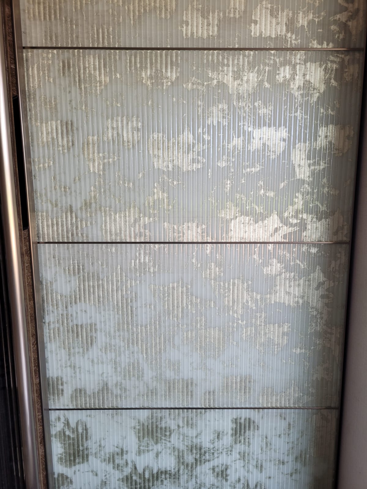 Fluted decorative panel — Vertical fluting combined with a scattered metallic-looking pattern.