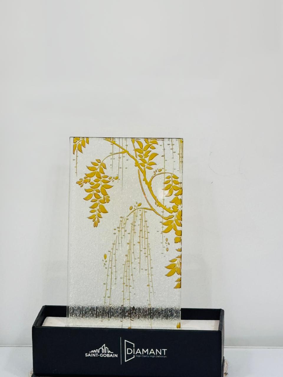 Hanging botanical glass — A gold botanical motif with a fine textured background.