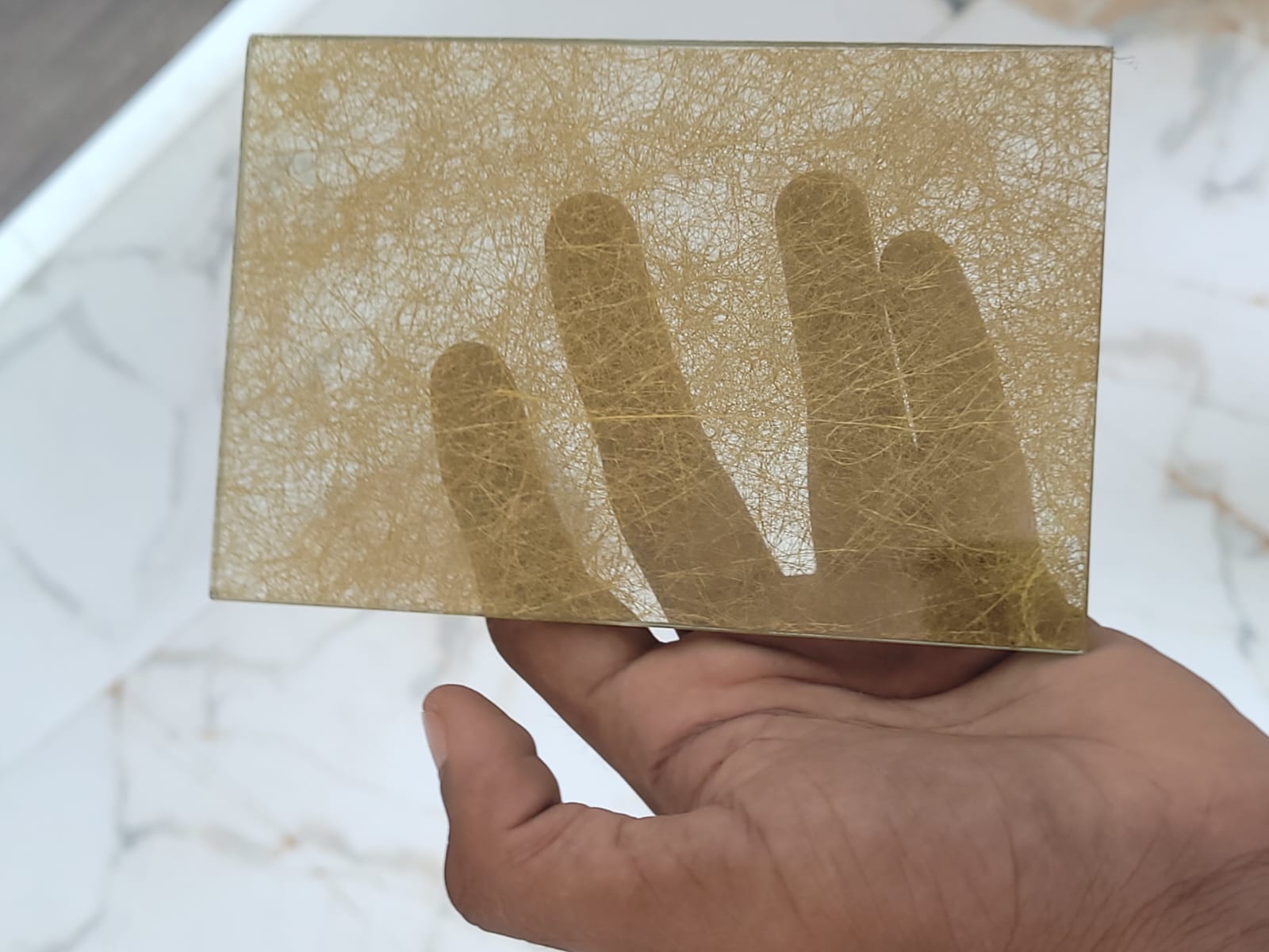 Gold fibre texture — A fine network of gold-toned fibres.