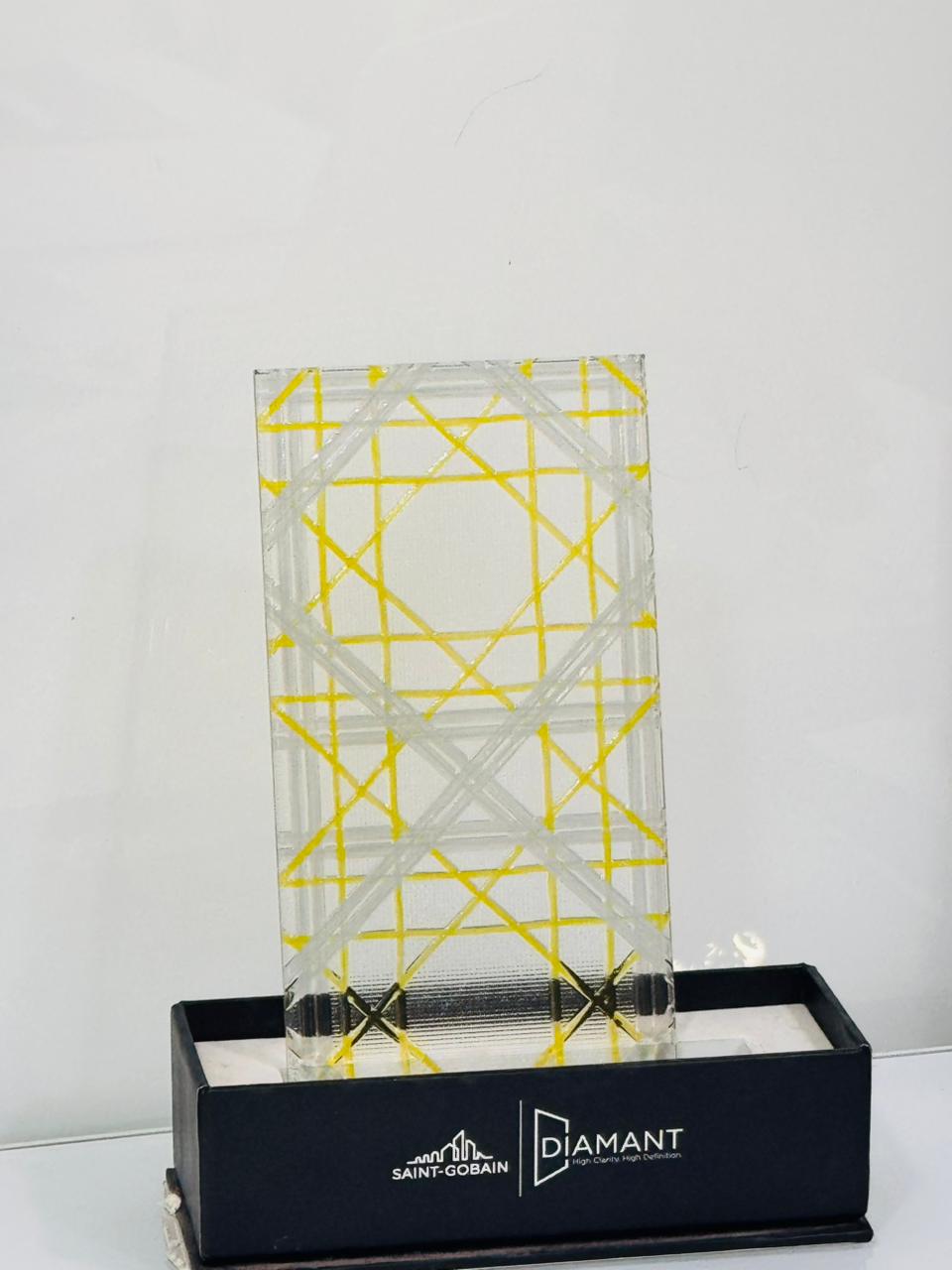 Gold geometric glass — Gold intersecting lines over a clear patterned pane.