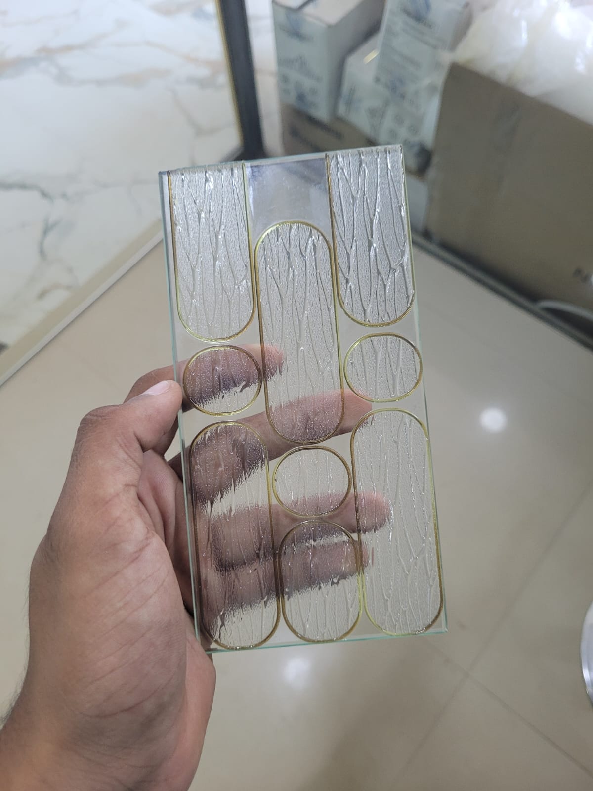 Rounded-line glass — Gold outlines and textured, elongated shapes.
