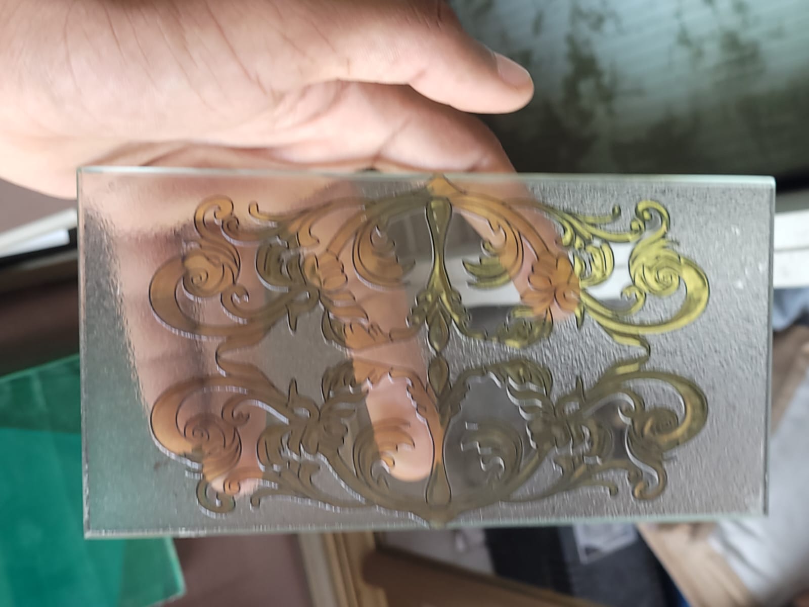 Ornamental scroll glass — An ornate scroll pattern with clear and textured areas.